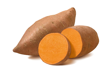 A sliced sweet potato in front of a whole sweet potato.